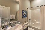 Spacious guest bathroom with tub/shower combination